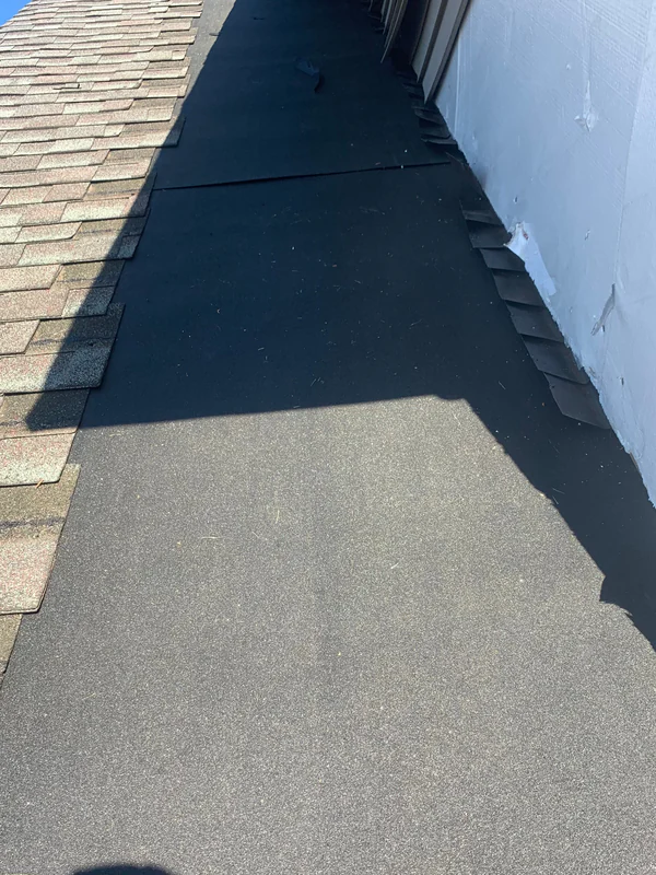 New underlayment laid along the dormer wall where the shingles were removed