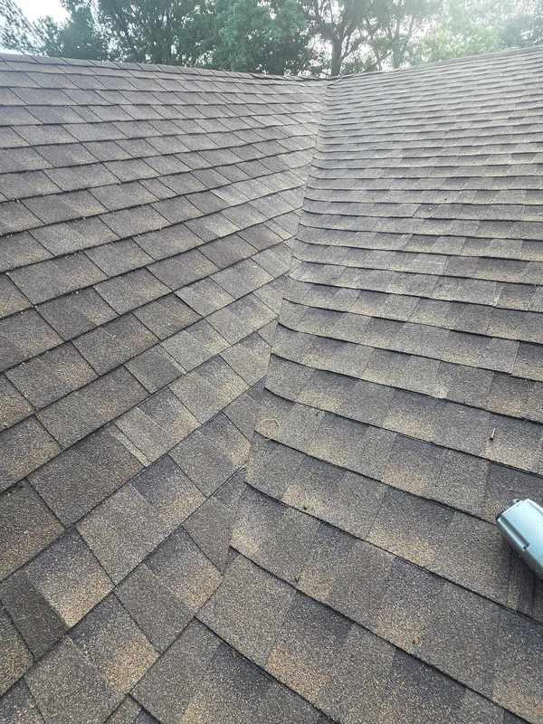 Finished shingle repair in a valley where two roof slopes meet